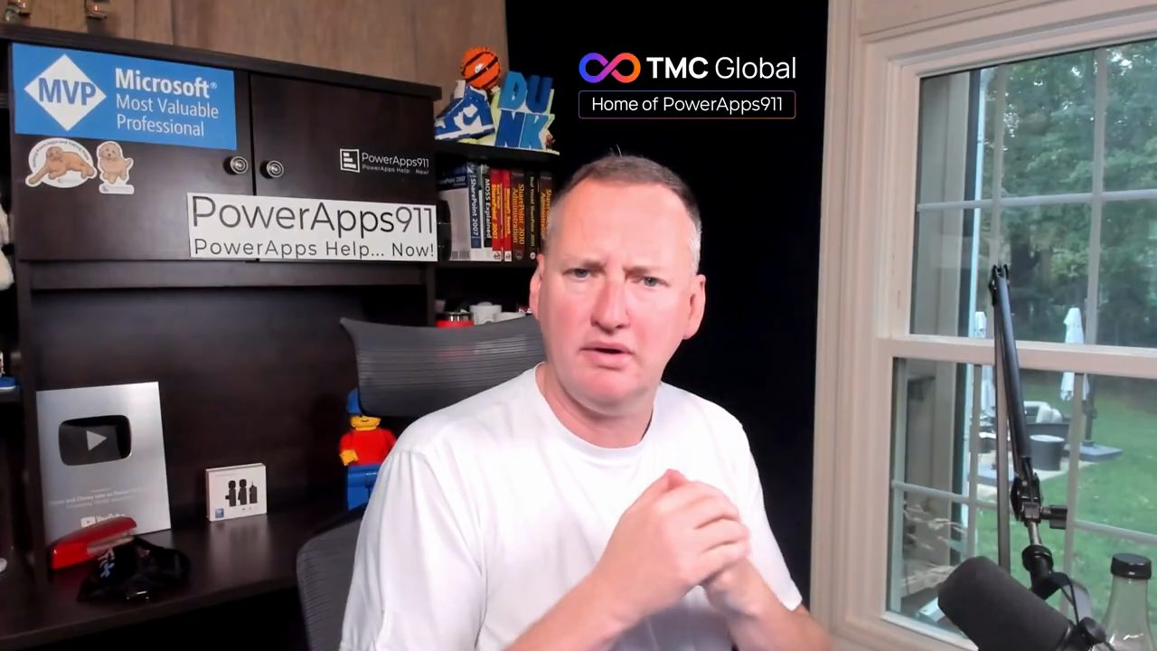 Shane Young nói trước camera trong phòng làm việc, góc trên có logo TMC Global, Home of PowerApps911