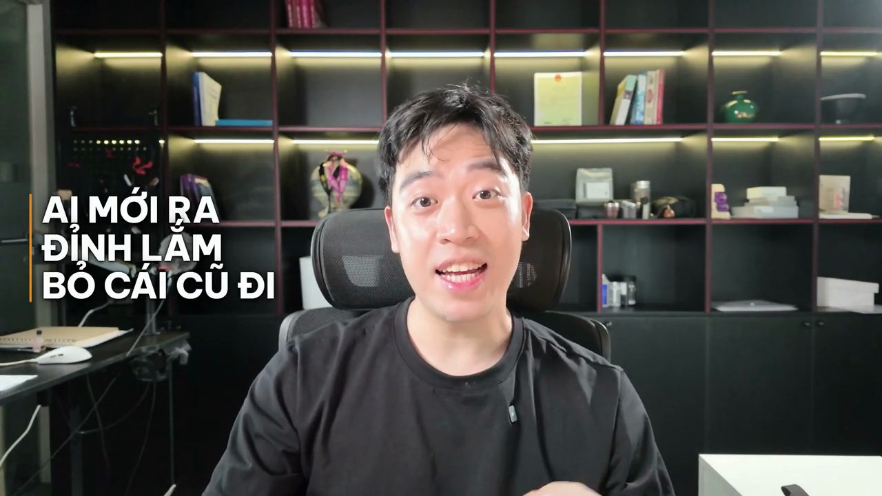 Thanh Trần ngồi trước kệ sách, chữ lớn bên trái ghi AI mới ra đỉnh lắm, bỏ cái cũ đi