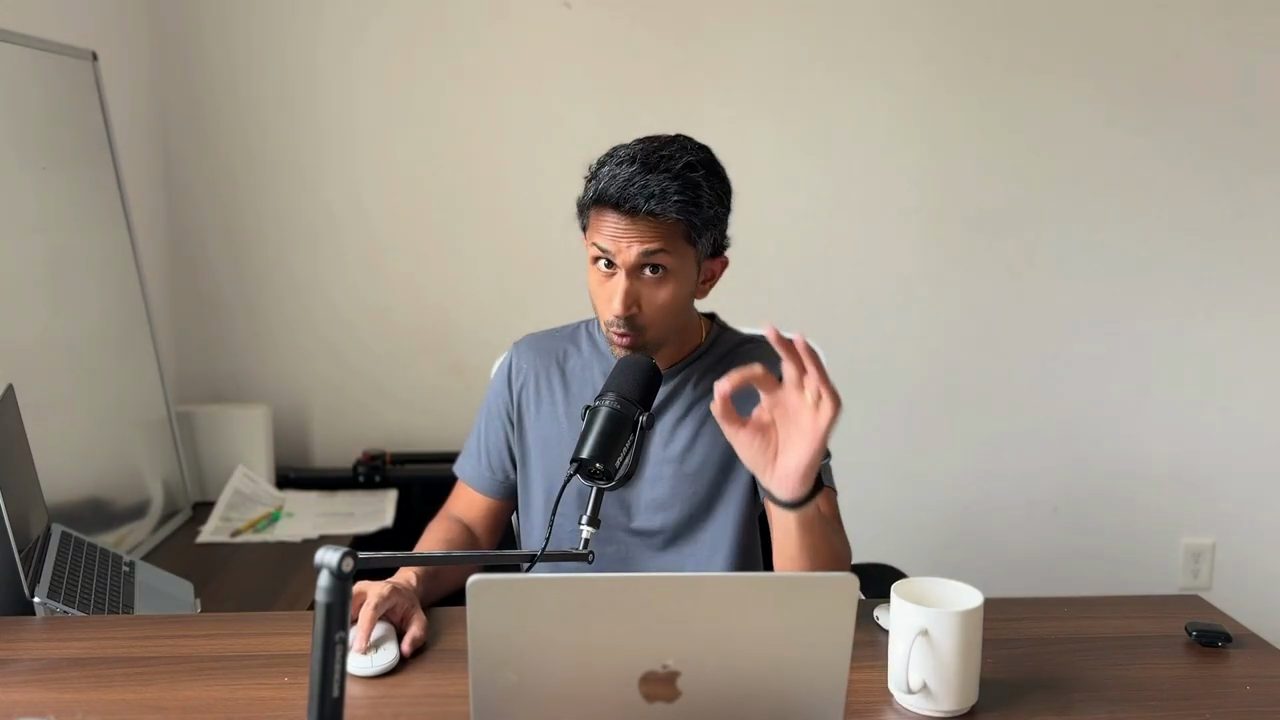 Sujay Nadkarni ngồi ở bàn làm việc, nói trước micro